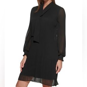 DKNY. Black pleated shift dress. Crewneck. 
Long balloon sleeve. Hem abo…
